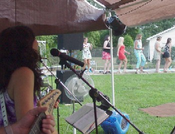 Click for enlarged view.  Conga line at a poolside wedding reception in July.