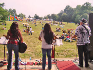 The field in front of the stage begins to fill with people.