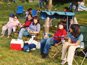 Veronica's relatives, including her mom in from the Philippines, and her sister, listen to the band perform