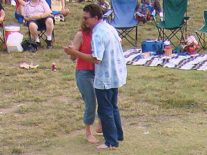 Dancing barefoot in the field during a romantic song. Hey...Oracle is a DANCE band after all, & we love seeing folks dance together.