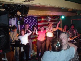 Click for enlarged view. The end of the evening, with everyone singing along to "Proud To Be An American" in front of the flag.