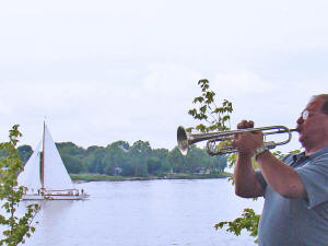 Oracle's trumpeter plays taps during a wreath laying ceremony that afternoon